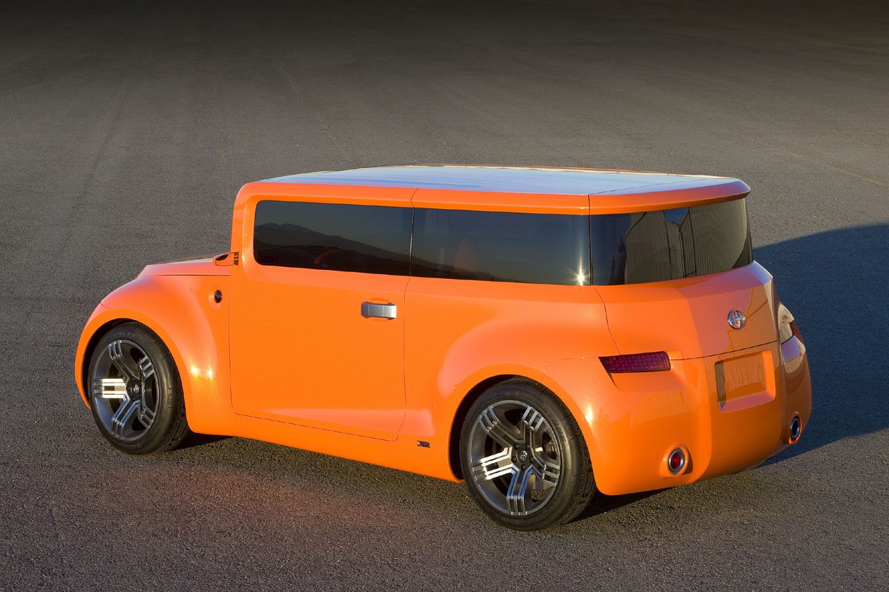 Orange Scion Hako Coupe concept car, seen from the rear three-quarter angle on dark pavement